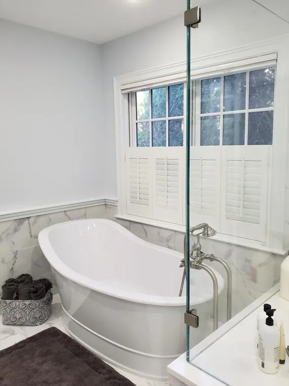 Bathroom with freestanding tub and window