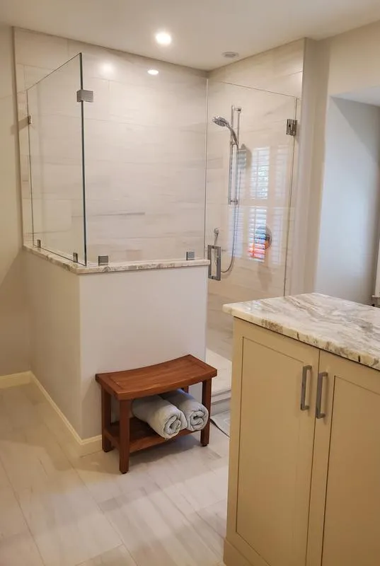 Glass-enclosed shower with teak bench