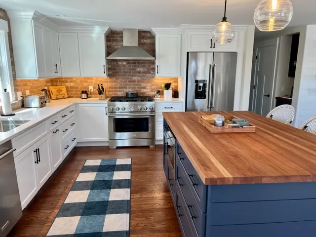 White kitchen with butcher block island and navy base