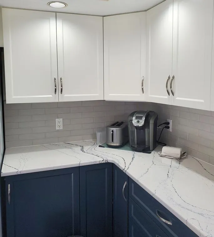White and navy cabinets with quartz counter