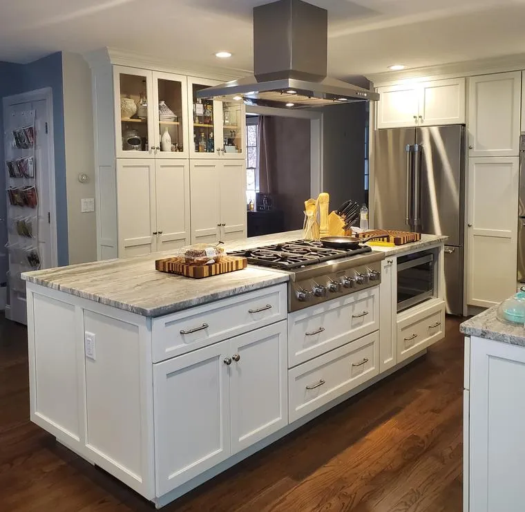 White kitchen island with range and hood