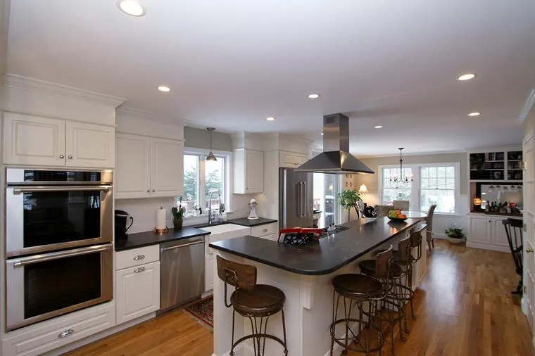 Open kitchen with double ovens and dark island
