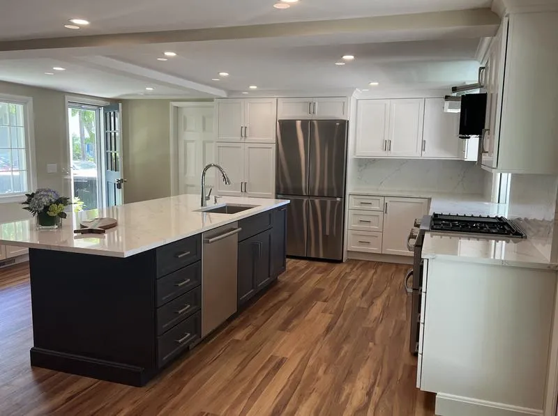 Kitchen with navy island and wood floors