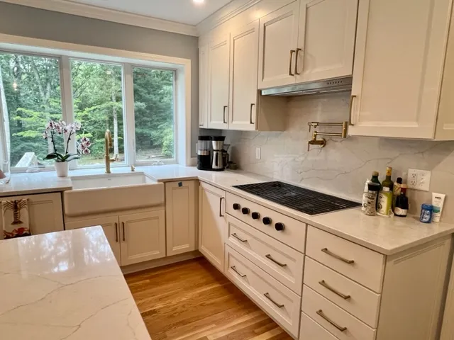 Kitchen with window over the sink and cooktop